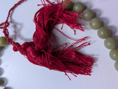 Traditional Green Bead Prayer Mala With Red Silk Tassels - Image 3